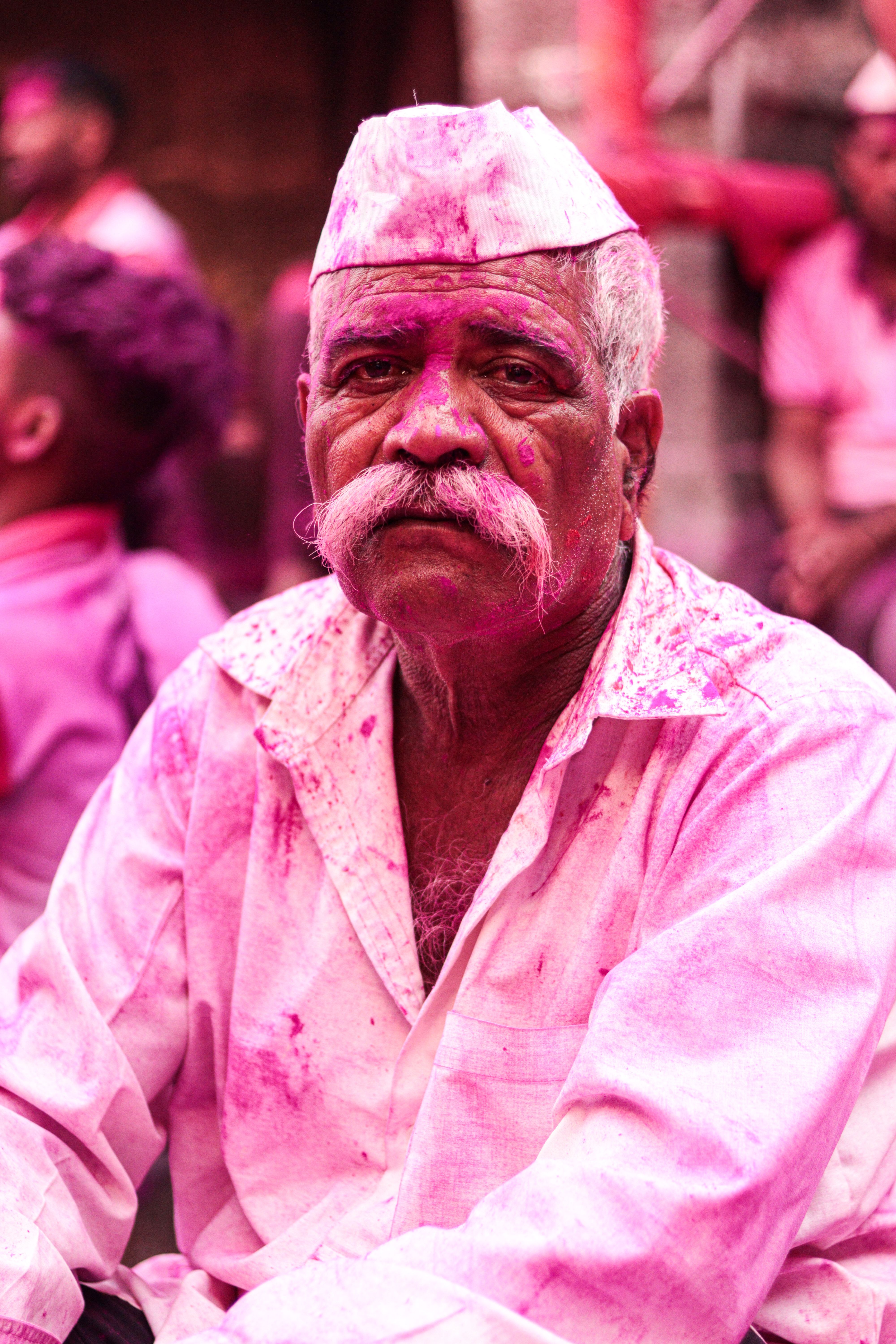 Man celebrating amid bright pink powder